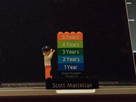 A picture of my desk with a small lego statue celebrating my 5 years at D2L.